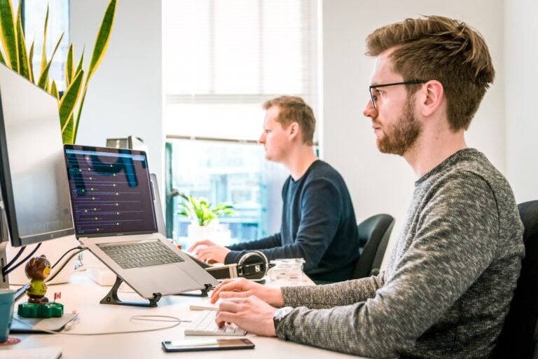 Developers testing AI coding assistants on a laptop
