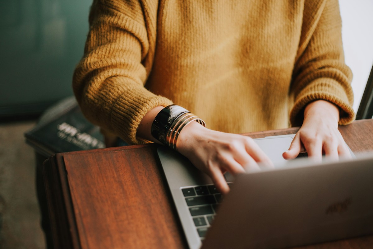 Translator setting up WordPress multilingual plugins while working on a laptop